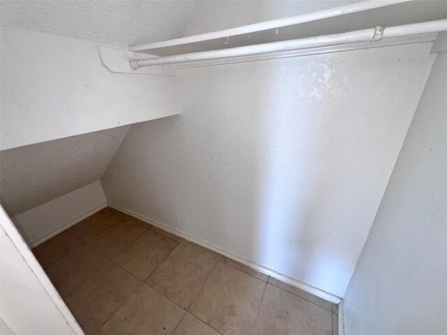 walk in closet featuring tile patterned flooring