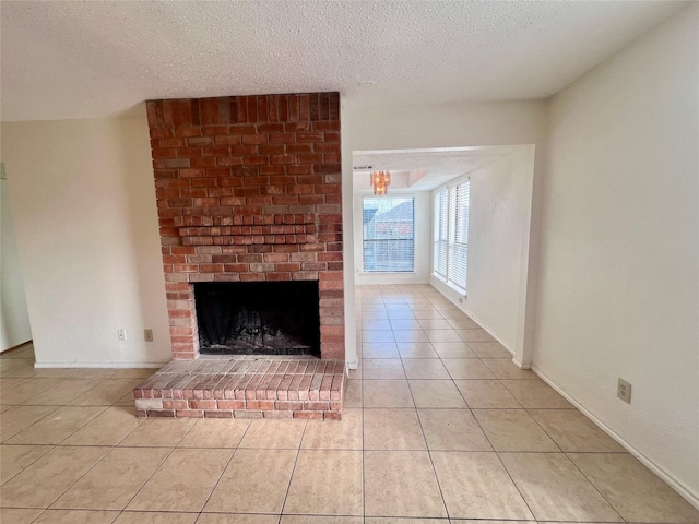 unfurnished living room with a fireplace, light tile patterned floors, and a textured ceiling