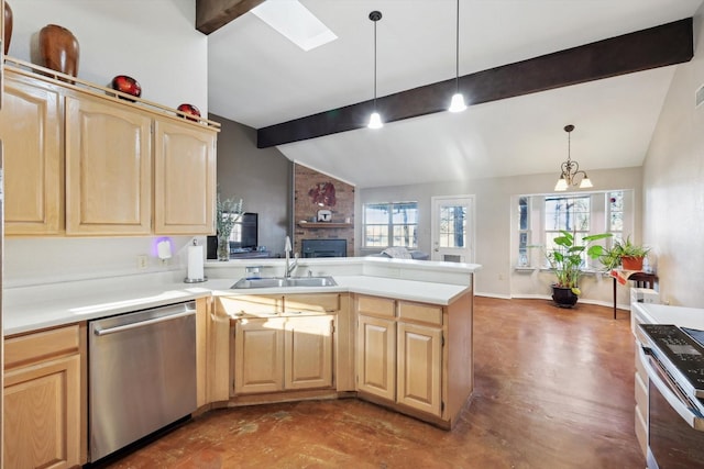 kitchen with lofted ceiling with skylight, dishwasher, and pendant lighting