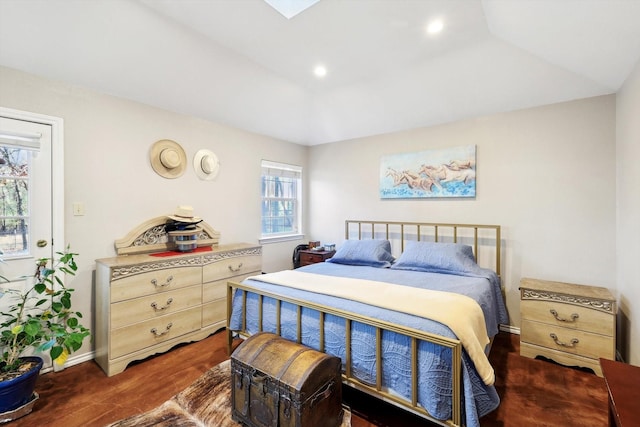 bedroom featuring dark hardwood / wood-style flooring, vaulted ceiling, and multiple windows