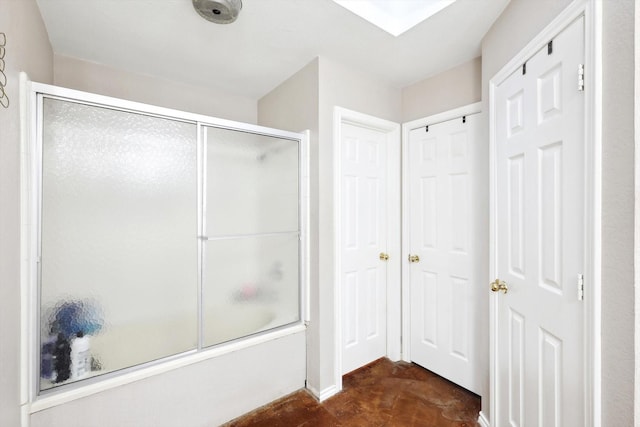 bathroom featuring combined bath / shower with glass door