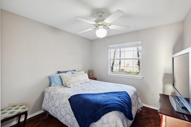 bedroom with dark hardwood / wood-style floors and ceiling fan