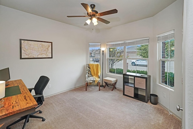 carpeted office with a wealth of natural light and ceiling fan