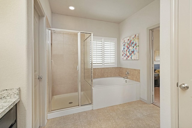 bathroom featuring vanity and plus walk in shower