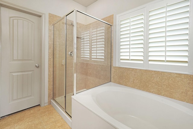 bathroom with tile patterned floors and plus walk in shower