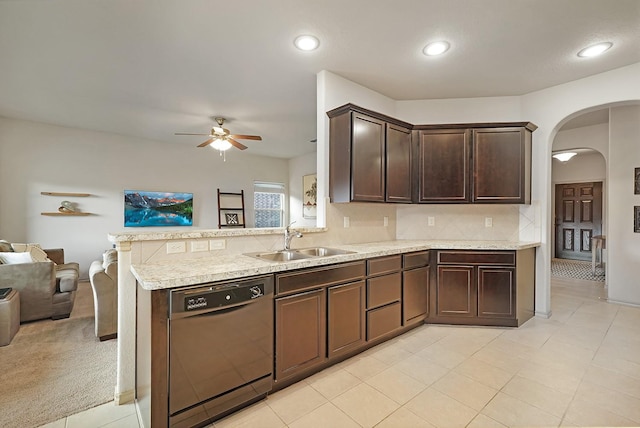 kitchen with kitchen peninsula, tasteful backsplash, dark brown cabinetry, sink, and dishwasher