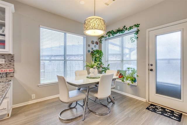 dining area featuring light hardwood / wood-style flooring and a healthy amount of sunlight