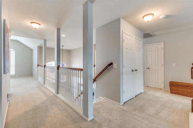 corridor with light colored carpet