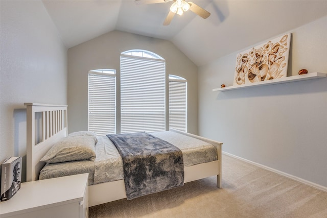 carpeted bedroom with ceiling fan and lofted ceiling