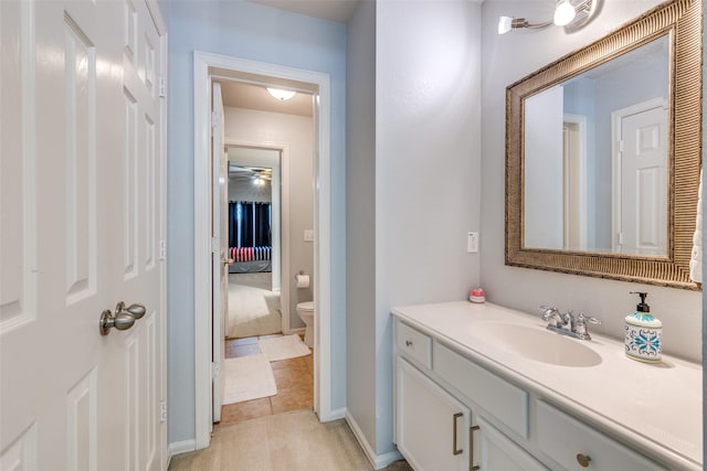 bathroom with tile patterned flooring, vanity, and toilet