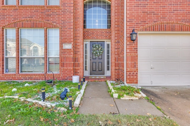 doorway to property with a garage