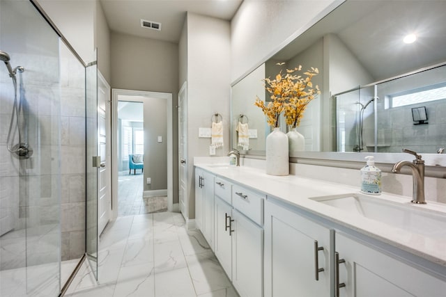 bathroom with vanity, a shower with shower door, and a towering ceiling