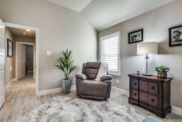 sitting room featuring light hardwood / wood-style floors and vaulted ceiling