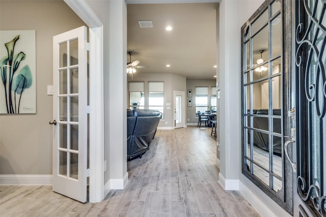 entrance foyer with french doors, light hardwood / wood-style floors, and ceiling fan