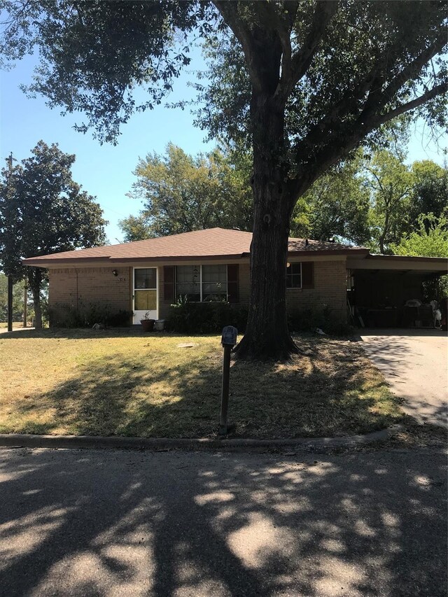 single story home featuring a carport