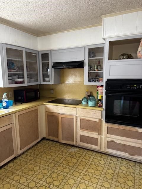 kitchen with black appliances and a textured ceiling