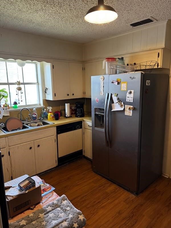 kitchen with dishwasher, sink, stainless steel fridge with ice dispenser, dark hardwood / wood-style flooring, and a textured ceiling