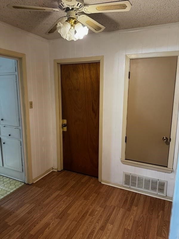 corridor featuring hardwood / wood-style floors and a textured ceiling