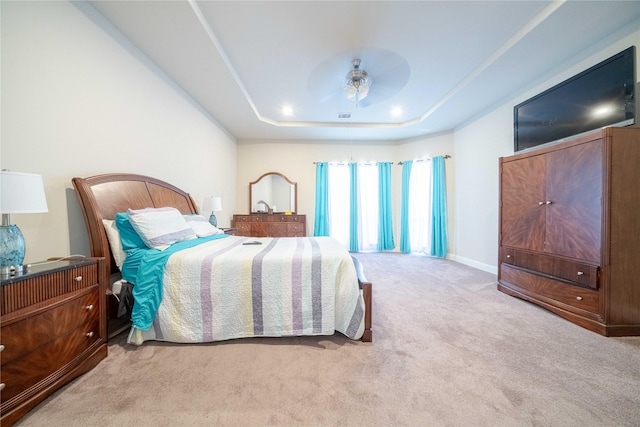 bedroom with baseboards, a raised ceiling, and carpet