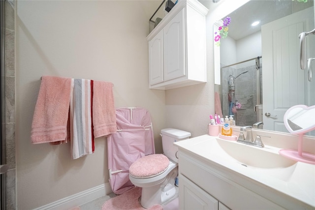 bathroom featuring vanity, toilet, and a shower with shower door