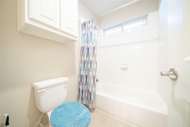 full bathroom featuring tile patterned flooring, toilet, and shower / bath combo