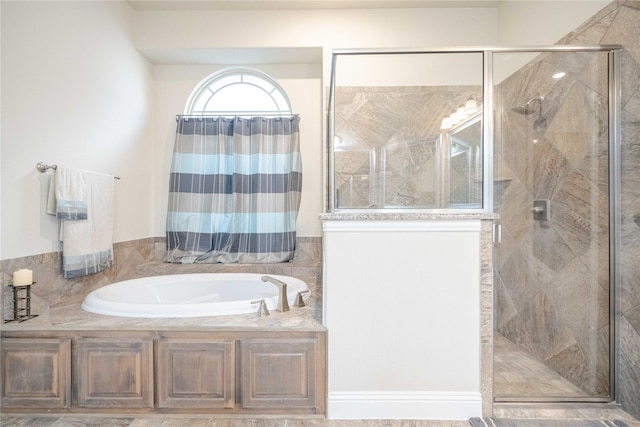 bathroom with a shower stall and a garden tub