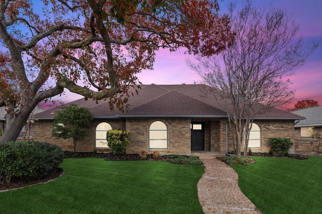 ranch-style house featuring a yard