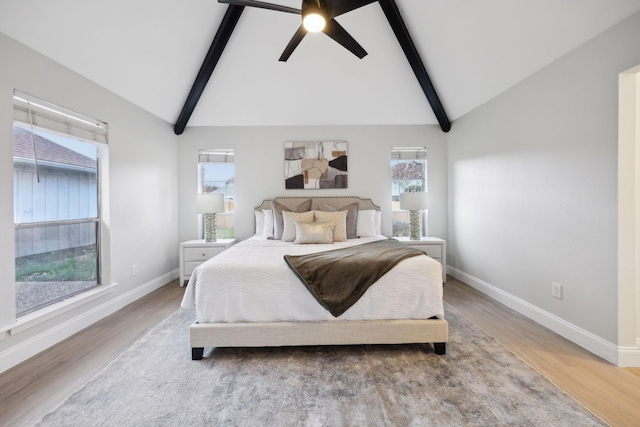 bedroom with hardwood / wood-style flooring, lofted ceiling with beams, and ceiling fan