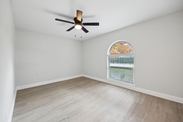 spare room with ceiling fan and light wood-type flooring