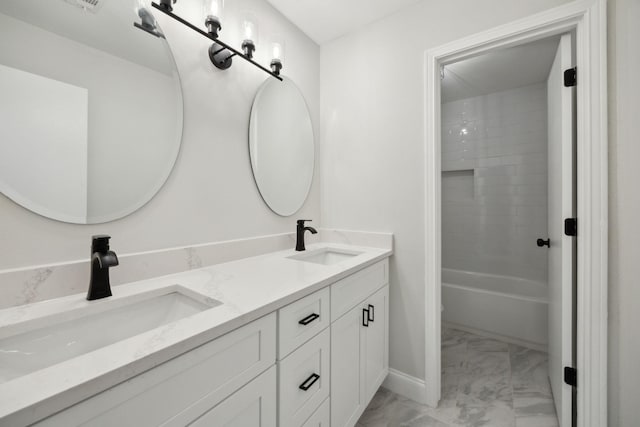 bathroom featuring vanity and tiled shower / bath combo