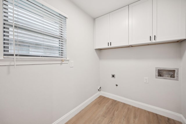 clothes washing area with electric dryer hookup, light hardwood / wood-style floors, cabinets, and hookup for a washing machine