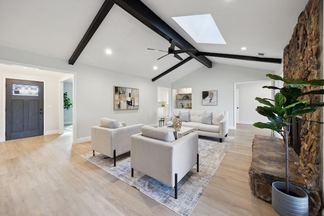 living room with vaulted ceiling with beams, light hardwood / wood-style flooring, and ceiling fan