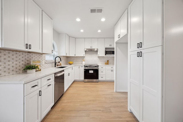 kitchen featuring white cabinets and appliances with stainless steel finishes