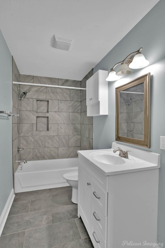 full bathroom featuring vanity, tiled shower / bath combo, and toilet