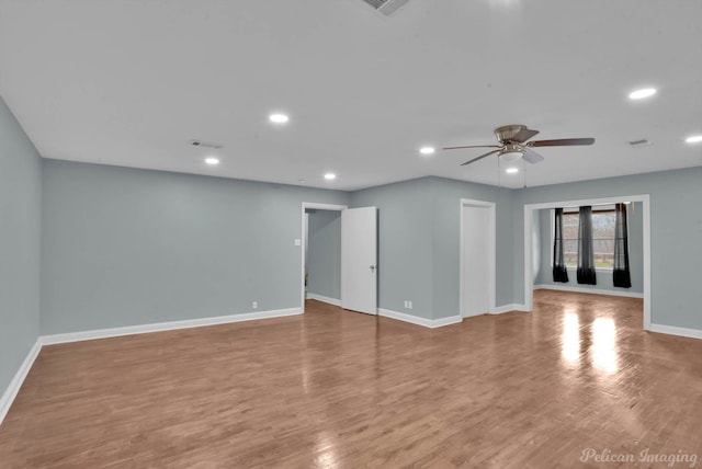 unfurnished room with hardwood / wood-style flooring and ceiling fan