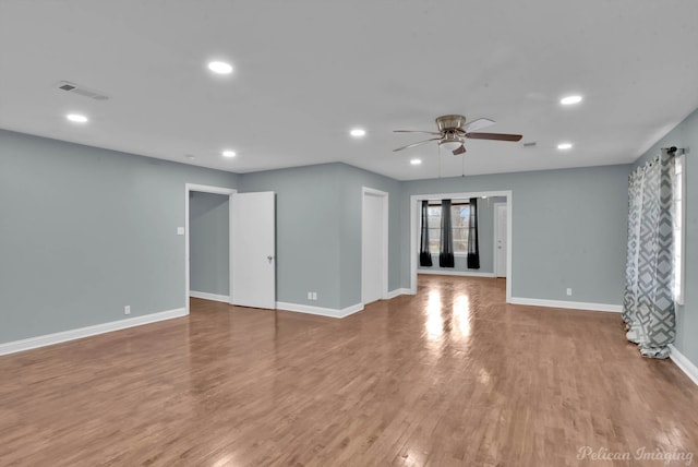 unfurnished room with hardwood / wood-style floors and ceiling fan