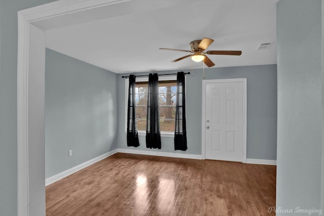 empty room featuring ceiling fan and hardwood / wood-style floors