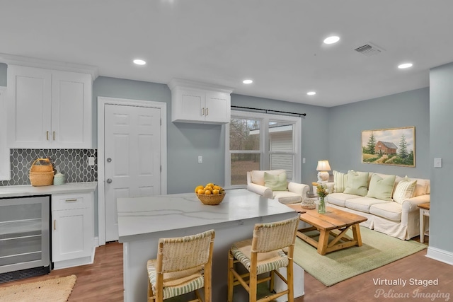6263 Bain Blvd, Keithville, LA 71047 - living area with beverage cooler, recessed lighting, wood finished floors, and visible vents