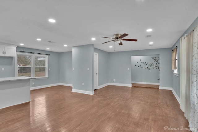 unfurnished living room featuring hardwood / wood-style flooring and ceiling fan