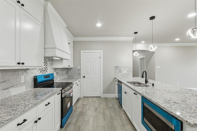 kitchen featuring sink, hanging light fixtures, stainless steel appliances, light stone counters, and white cabinets