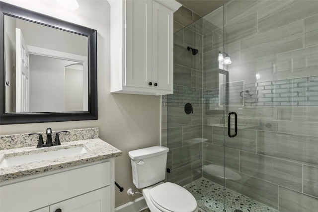 bathroom featuring vanity, toilet, and walk in shower