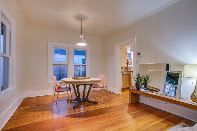 dining room featuring hardwood / wood-style flooring and crown molding