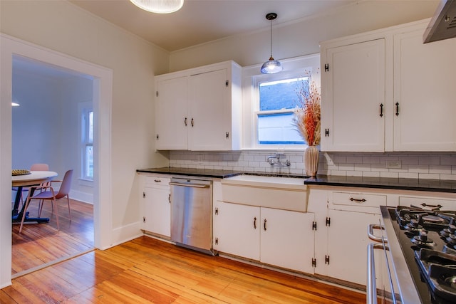 kitchen with white cabinetry, backsplash, pendant lighting, light hardwood / wood-style floors, and appliances with stainless steel finishes