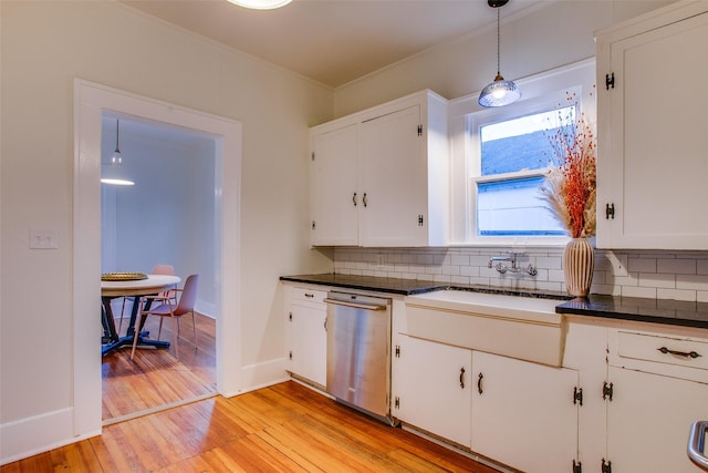 kitchen with stainless steel dishwasher, white cabinets, backsplash, and light hardwood / wood-style flooring