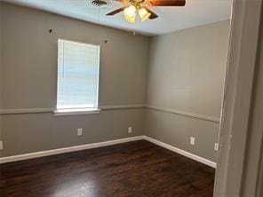 empty room featuring ceiling fan and dark hardwood / wood-style floors