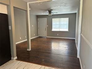 foyer entrance featuring ceiling fan and dark wood-type flooring