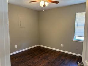 empty room featuring ceiling fan and dark hardwood / wood-style flooring