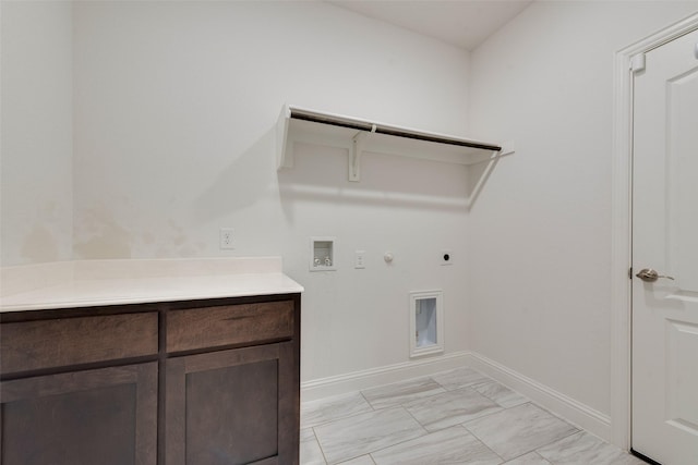 laundry area with electric dryer hookup, hookup for a gas dryer, cabinets, and washer hookup