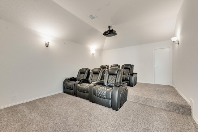 home theater room with carpet flooring and vaulted ceiling