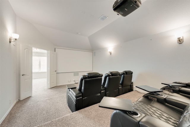 home theater with light carpet and vaulted ceiling